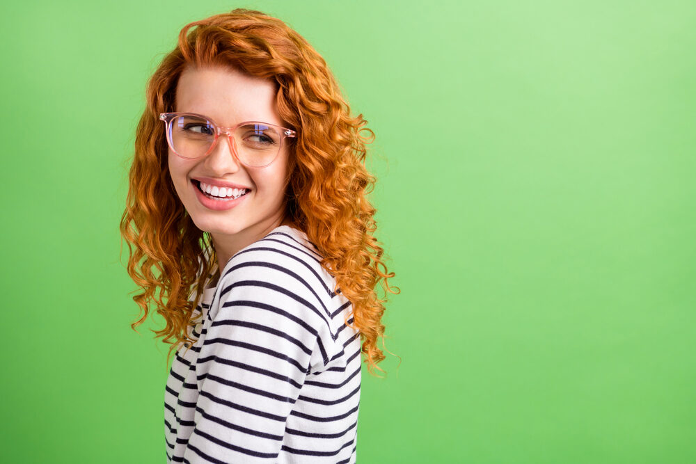 Female with a tanned white skin color with burnt-orange hair pigmentation.