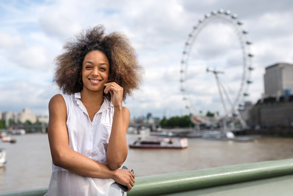 African American female with frizzy hair that's been lightened with lemon juice instead of harsh chemicals.