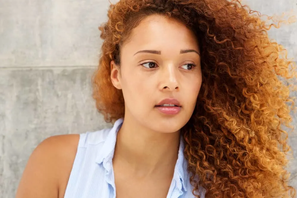 Does Color Oops Damage Hair? How to Use Color Oops Without Damage 7 Beautiful young woman with natural black hair that's been bleached and dyed a red color