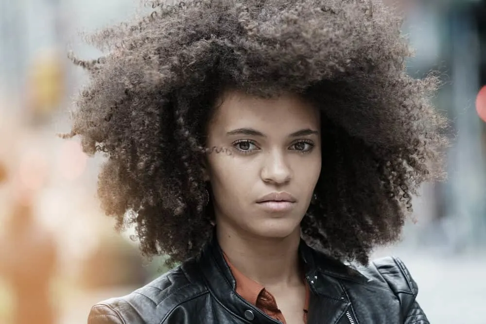 The 7 Gradual Stages of Lightening Dark Hair To Icy Blonde or White 1 Mixed-raced lady with medium brown hair wearing a black leather jacket