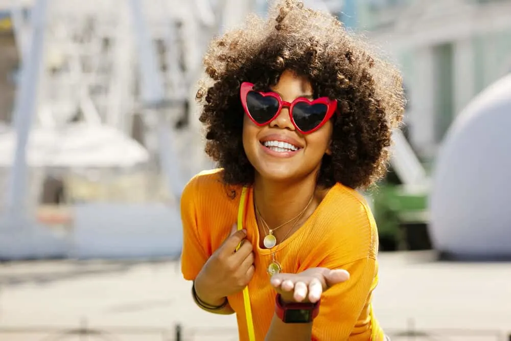 Does Pantene Cause Hair Loss? What About Their Shampoo and Other Products? 4 Charming lady with a great smile and 3C curls styles with natural products.