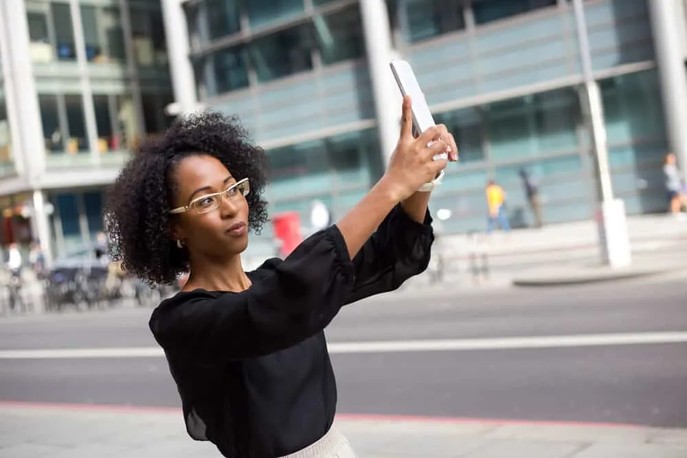 Hair Breakage on Top of Your Head: Causes, Fixes, Products, and More 2 African American female with curly fine hair wearing a wash n go hairdo with styled baby hairs.