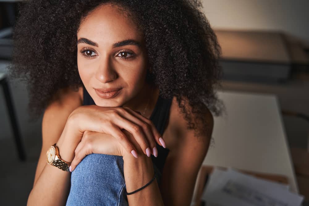 Does toner damage your hair 3 Stunning black female dark brown fragile hair strands wearing a black t-shirt, jeans, and boots