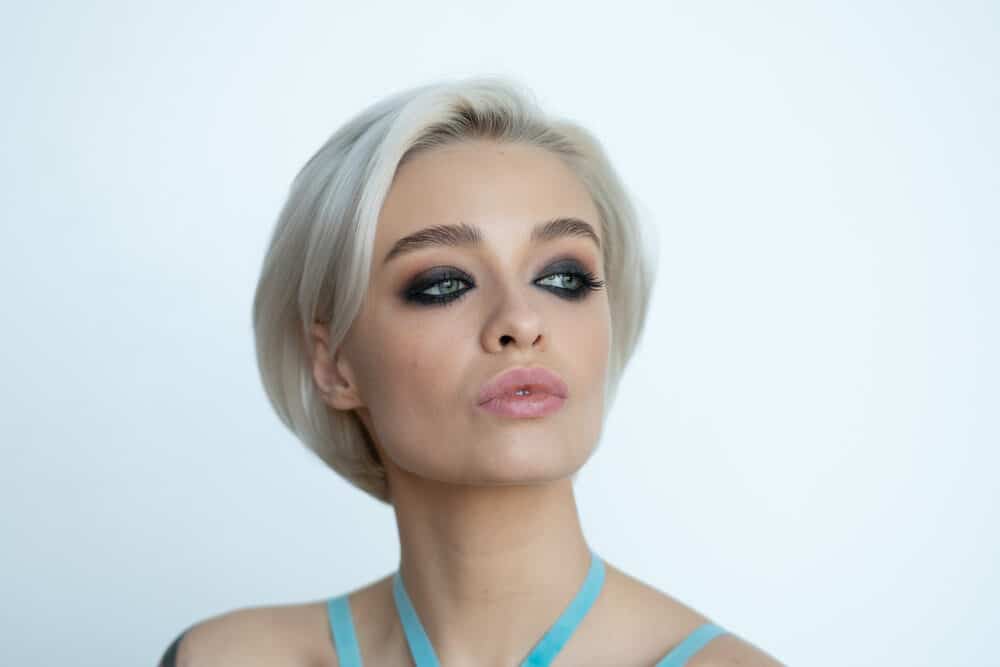 White girl with a bob hairstyle on naturally dark hair bleached before applying toner