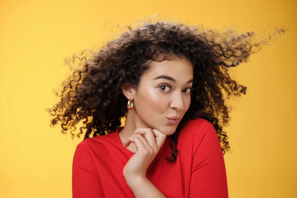 When Can I Wash My Hair After a Perm? What Happens if You Wash It Too Early? 6 Adult female leaving her hair stylist with color treated hair and permanent wave pattern after a new hairdo.
