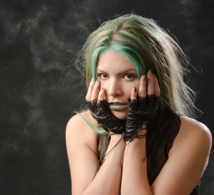 Pretty young girl hoping to get green out of hair with purple shampoo after her light blonde hair turned green.