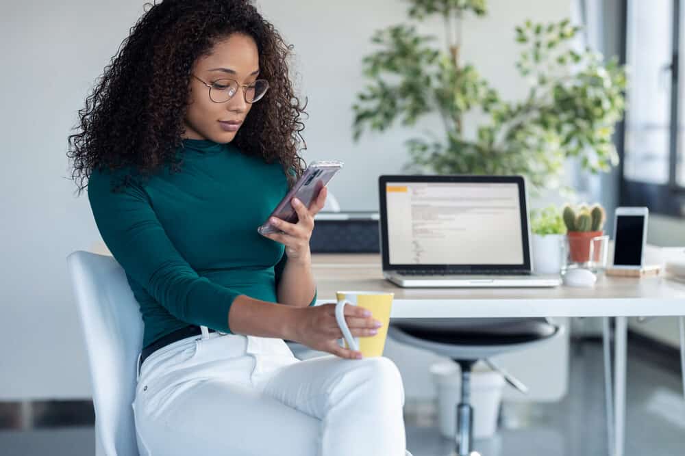 Why Is My Hair Resistant to Perms? Causes and Treatments 4 Confident female with naturally straight hair that's curled with perm rods after a deep conditioning treatment.