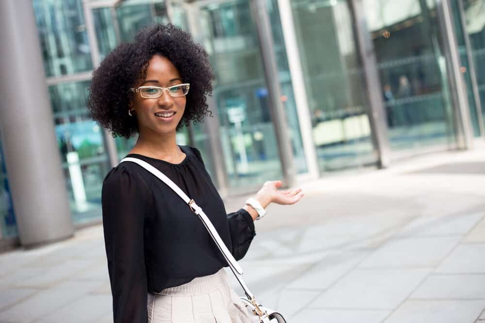 Young African American lady with healthy hair wearing a curly twist-out hair style on a 4B hair type.