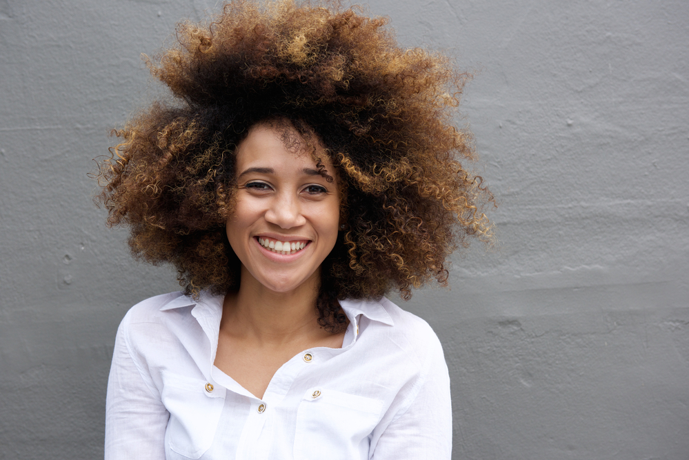 Young woman with pre-lightened hair dyed with semi-permanent hair color.