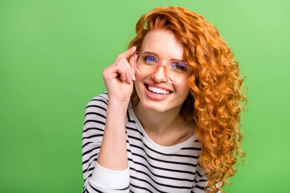 Cute white girl with darker hair trying a new pair of rose-colored glasses.