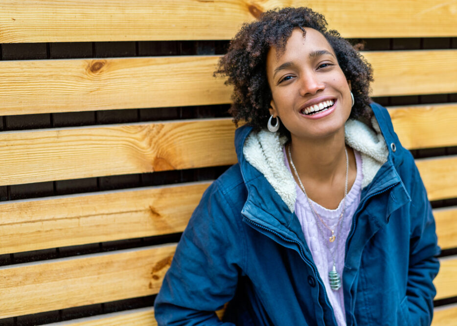 Cute black lady with thick hair that doesn't absorb moisture quickly due to her hair's porosity.