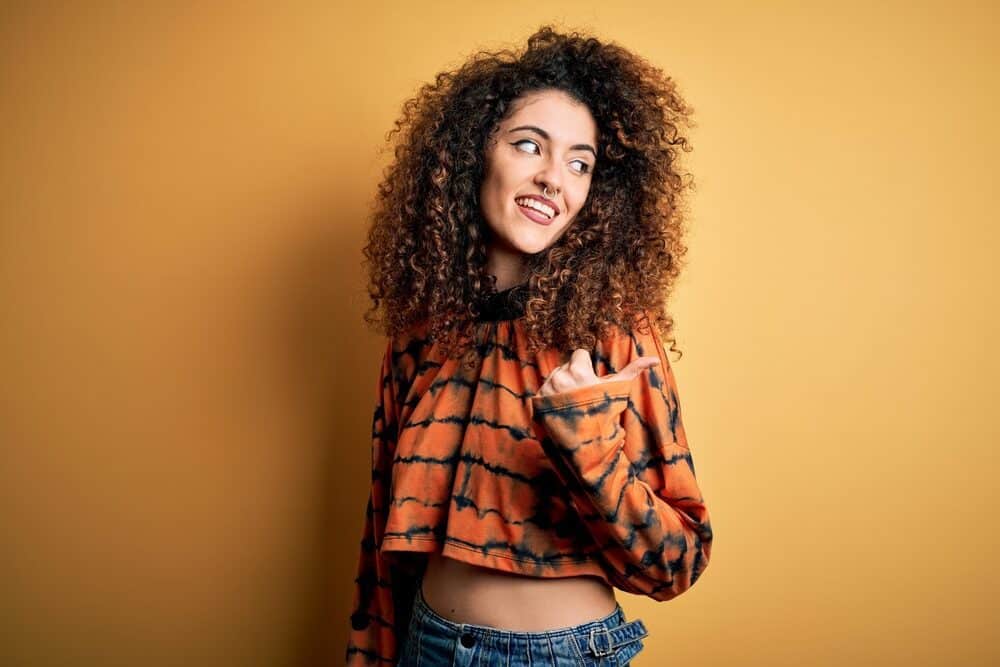 A white woman wearing casual clothes with fine hair made fluffy with cheaper hair extensions.