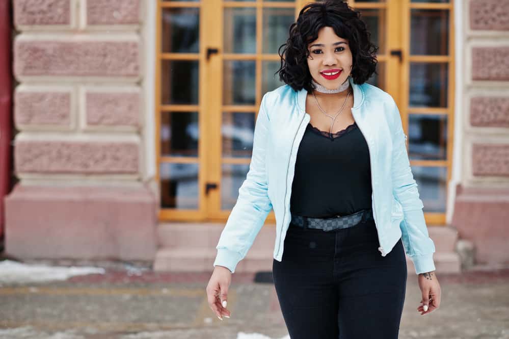 Black woman with a warm skin tone and oval face length wearing a long bob style and a dark brown hair color.