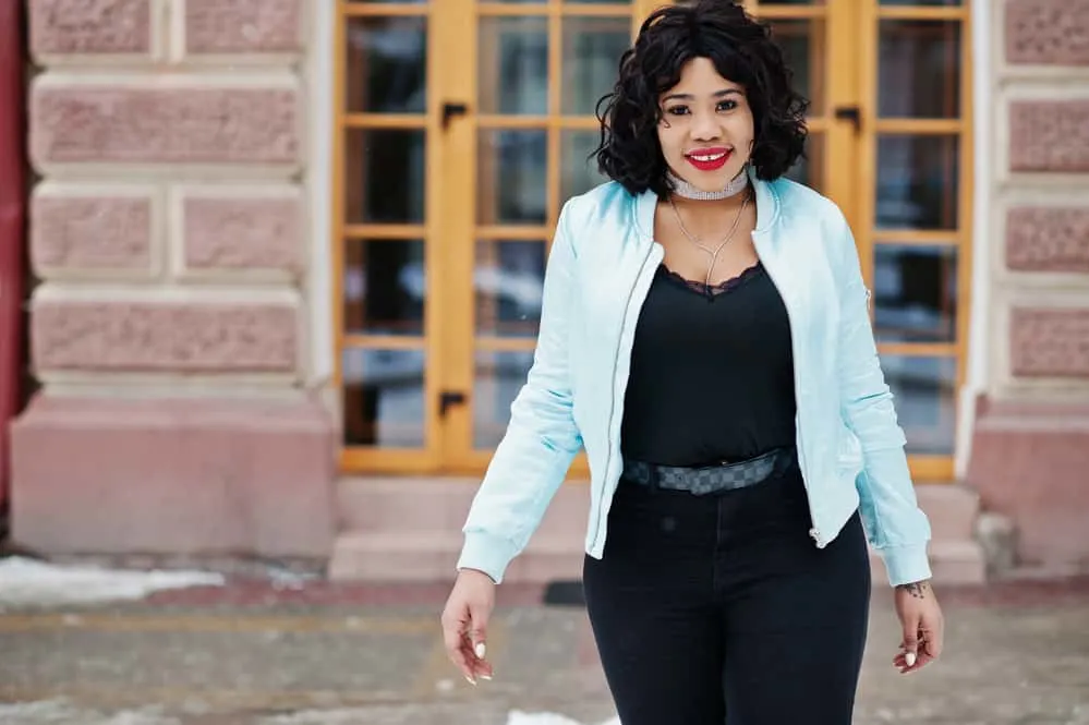 Does Short Hair Make You Look Fatter or Thinner? Plus Tips 6 Black woman with a warm skin tone and oval face length wearing a long bob style and a dark brown hair color.