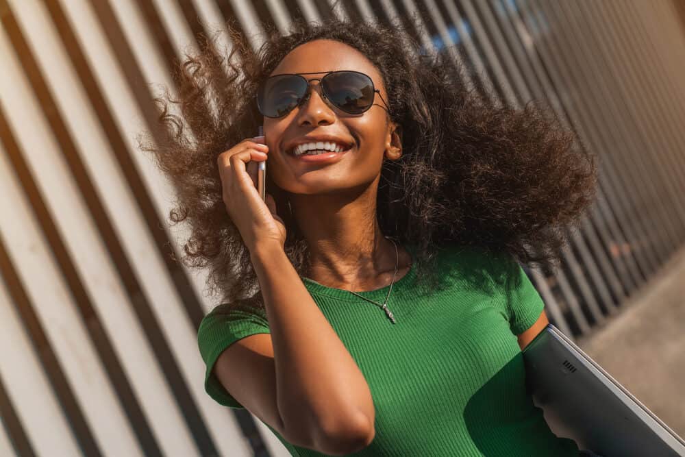 A beautiful woman with curly hair is concerned that she'll permanently damage hair strands with curling wands.