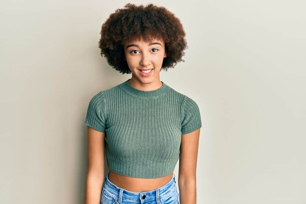 Does Curly Hair Grow Slower Than Straight Hair? 1 Young Hispanic girl with naturally curly healthy hair wearing a wash n go after leaving the hair stylist.