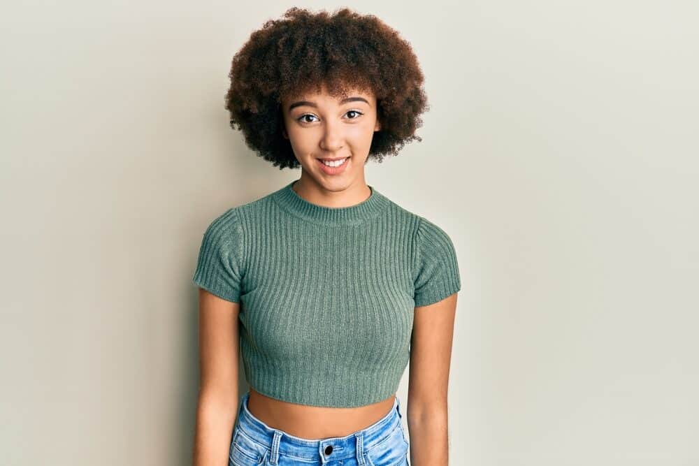 Young Hispanic girl with naturally curly healthy hair wearing a wash n go after leaving the hair stylist.