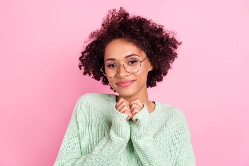 Gorgeous black lady with a brunette hair color with warm undertones wearing a wash and go hairdo.