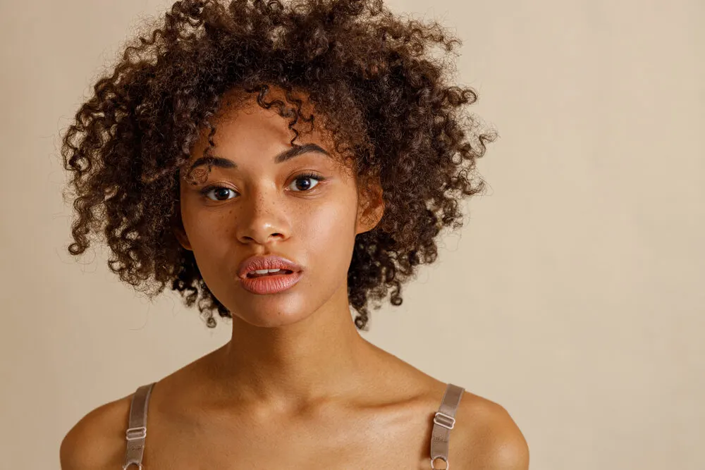 Is Volume Powder Bad for Your Hair? What Is It? Is It Safe? 4 Gorgeous multiethnic woman with thinning hair treated with texturizing powder to create volume.