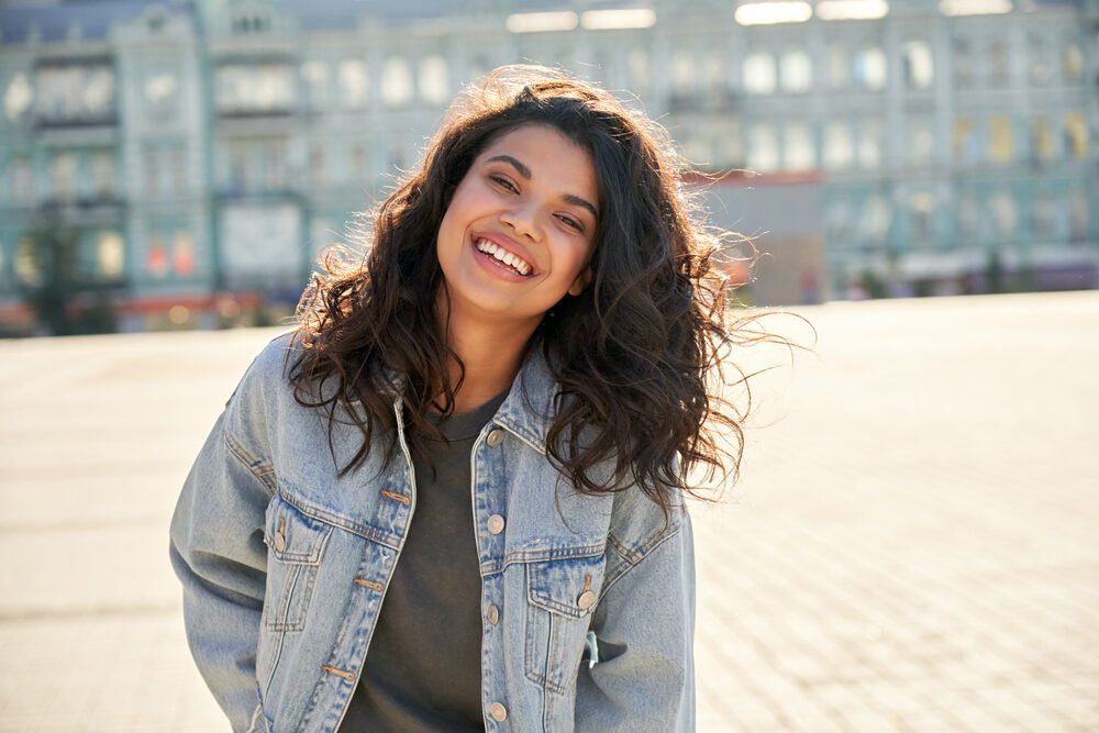 Cute black girl with bra-strap hair length after leaving a hair stylist with a good haircut focused on split-ends.