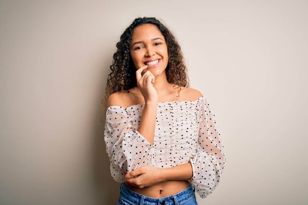 Cute light-skinned girl with beautiful white teeth wearing a new style after leaving her stylist.