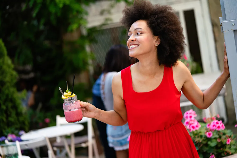 Beautiful black woman with unnoticeable thin facial hair treated by waxing to slow the hair cycle. 