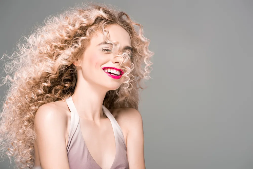 Learn How To Neutralize Pink Undertones in Hair With Our DIY Guide 5 A happy female with thick hair dyed her hair pink for an upcoming party with friends.