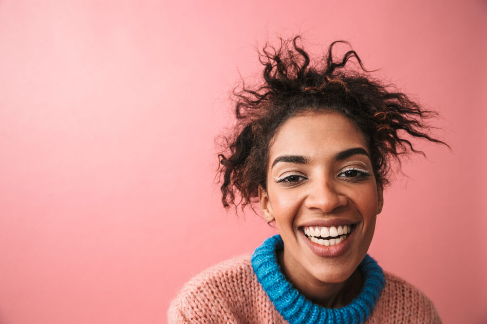 Beautiful African woman with an awesome smile and a dark brown hair color.