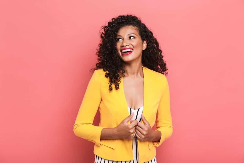 Gorgeous African American female wearing summer clothes with shoulder-length curls.