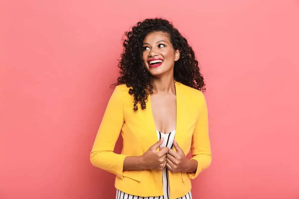Is Curly Hair Attractive? Why? What Do Guys Think? 4 Gorgeous African American female wearing summer clothes with shoulder-length curls.
