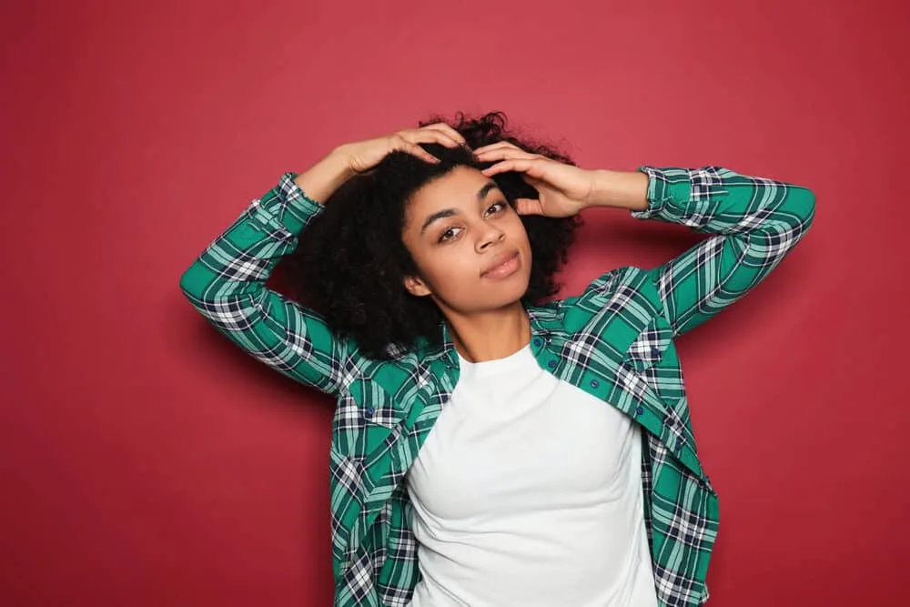 Does Henna Expire? How Long Does Henna Last After Mixed 3 Adult female with a twist-out hairdo styled with olive oil and lemon juice on 4A curls that are a rich brown color.