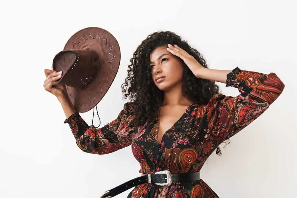How To Get Rid of Tension Bumps on Scalp: Will They Go Away? 13 A beautiful young woman with 3B curls dressed like a 1950s cowgirl from a western movie.