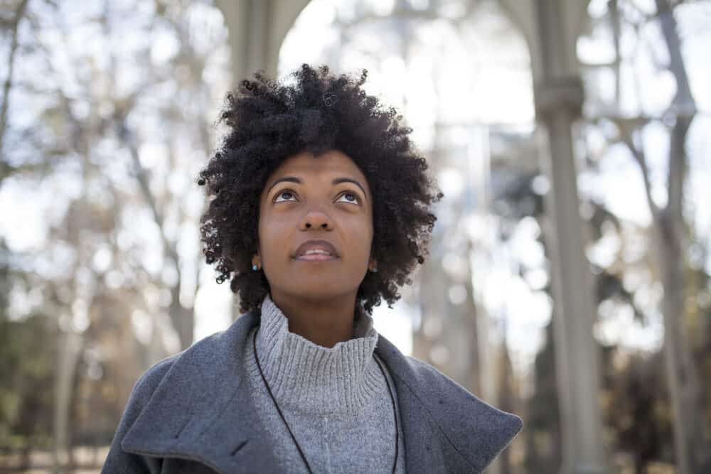 Gorgeous black female on an autumn day wearing a gray jacket with a mini afro styled with extra virgin coconut oil.