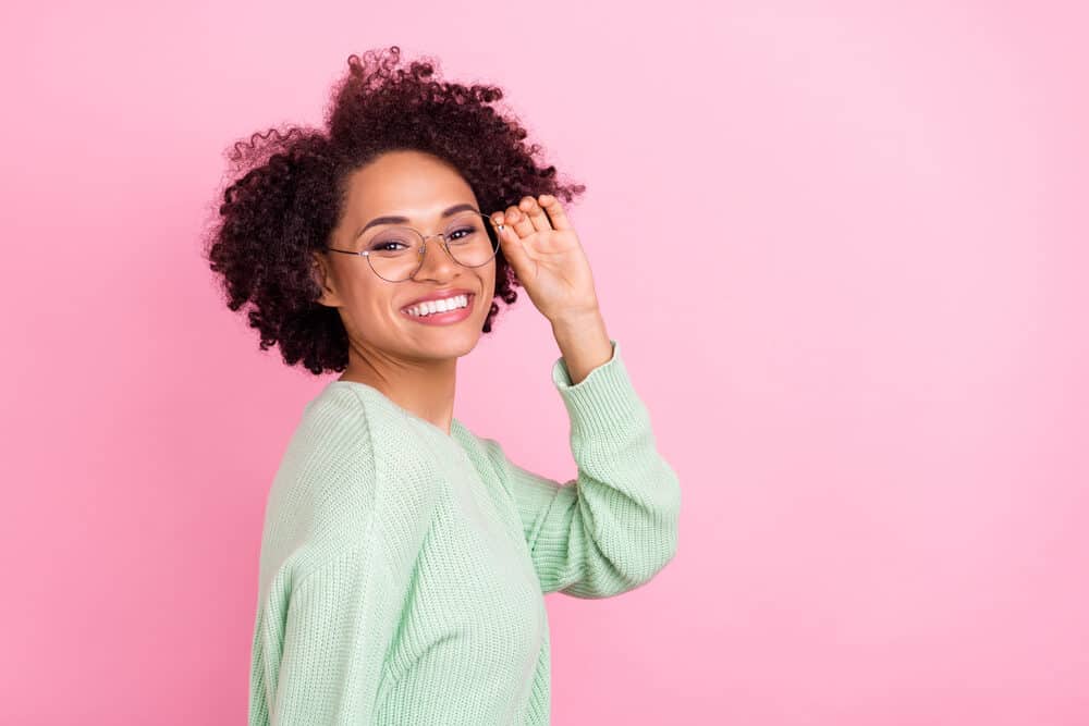 Black lady with color-treated hair leaving a hair stylist after using color-safe shampoo to style her bouncy twist-out hairstyle.