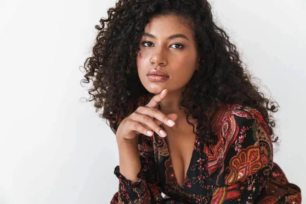 How To Get Rid of Tension Bumps on Scalp: Will They Go Away? 6 Beautiful American female with synthetic hair extensions wearing a colorful dress and natural-looking makeup.