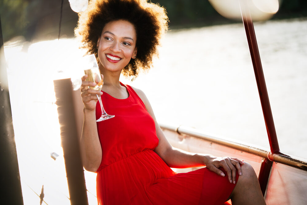 A stunning black woman with bouncy 4B curls from healthy hair care practices.