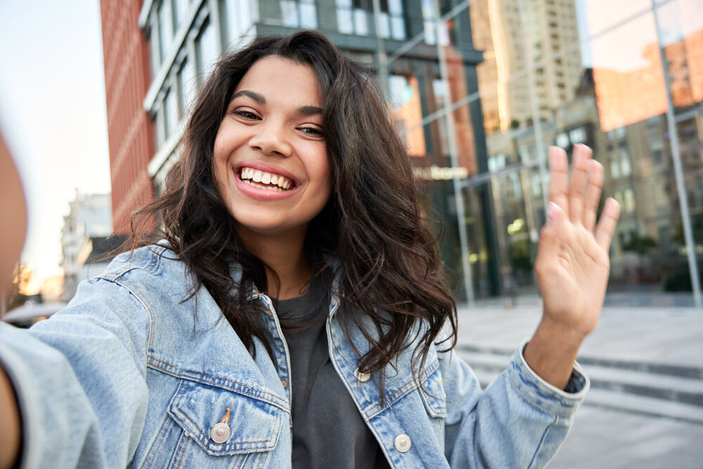 Happy African American female with so much more energy after she drastically cuts naturally curly hair.