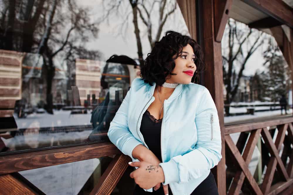 Stylish black girl wearing her hair short and a bit messy in a bob hair style.