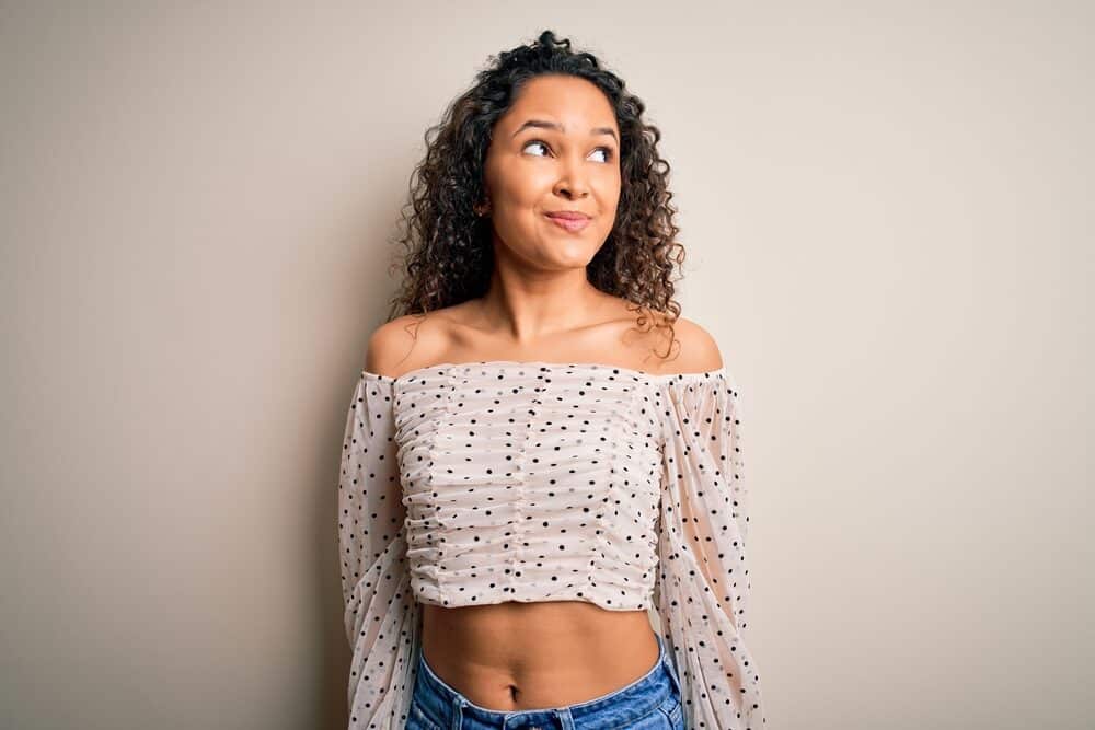 Cute mixed race black girl with a new wavy hairstyle after her hair growth reached bra-strap length.