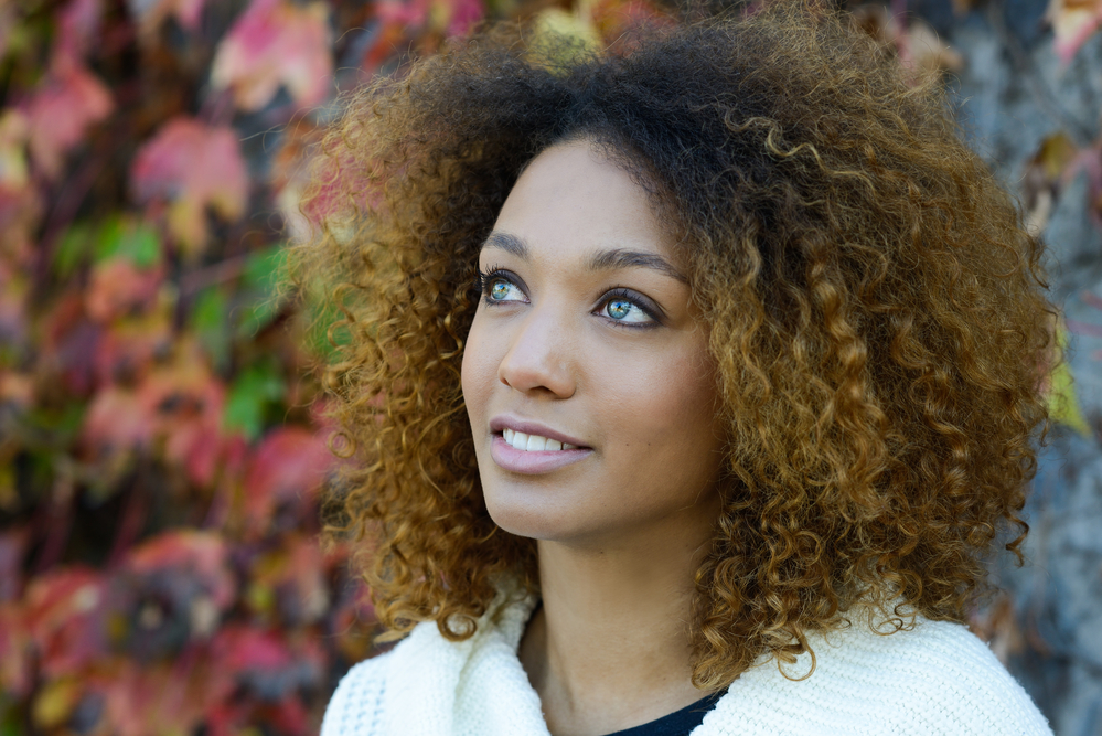 Cute black girl with dark brown hair that has a reddish tint after an unsuccessful coloring process.