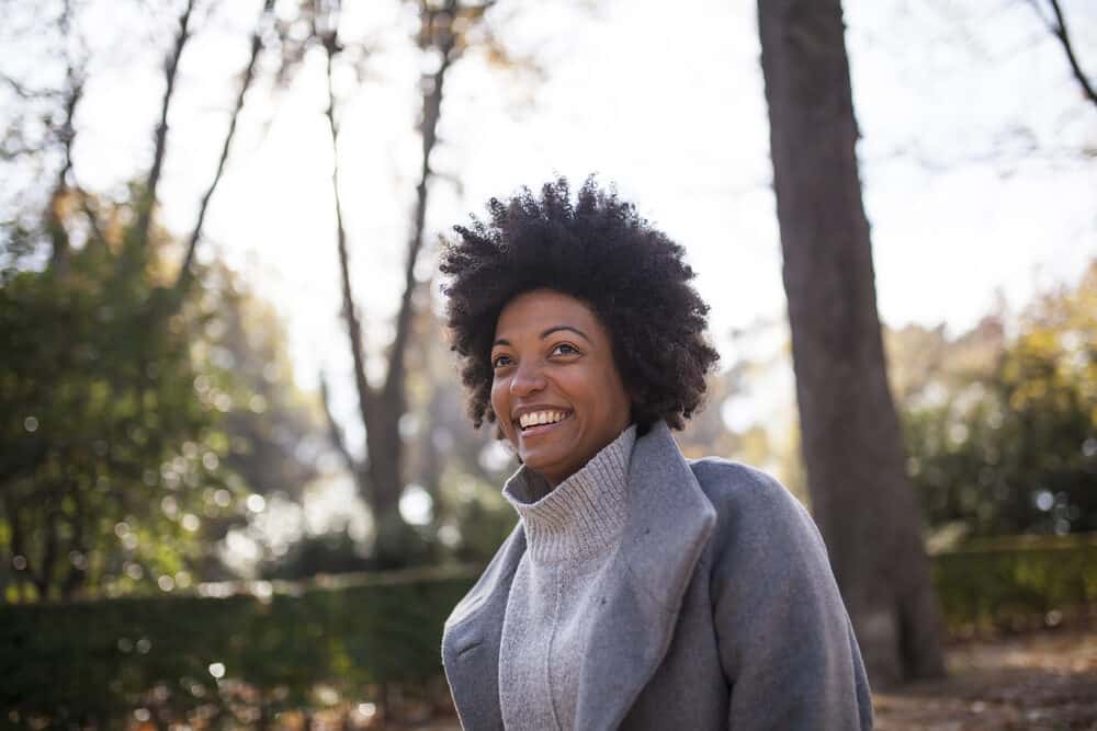 Cute black girl wearing a wash n go hairstyle created with refined oil extracted from dried coconut flesh.