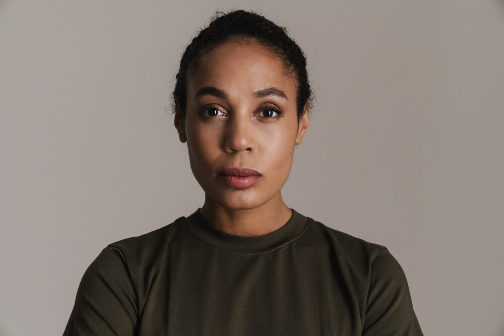 Black lady wearing a sleek ponytail that aligns with the military's guidance for female soldiers.