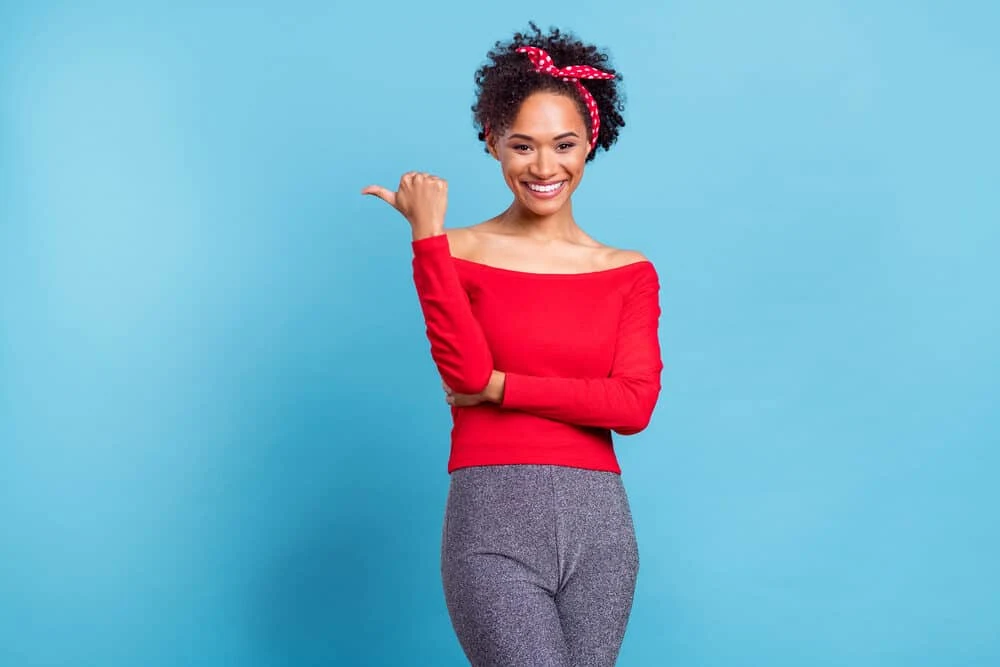 Can I Condition My Hair Everyday Without Shampooing? 5 Cute African American female with a 3B hair type wearing a red shirt and gray pants.