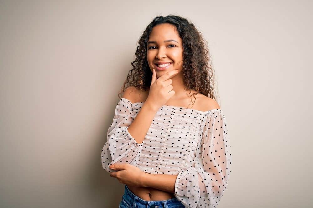 A mixed lady with fresh balayage highlights after leaving the hair salon for a full service.