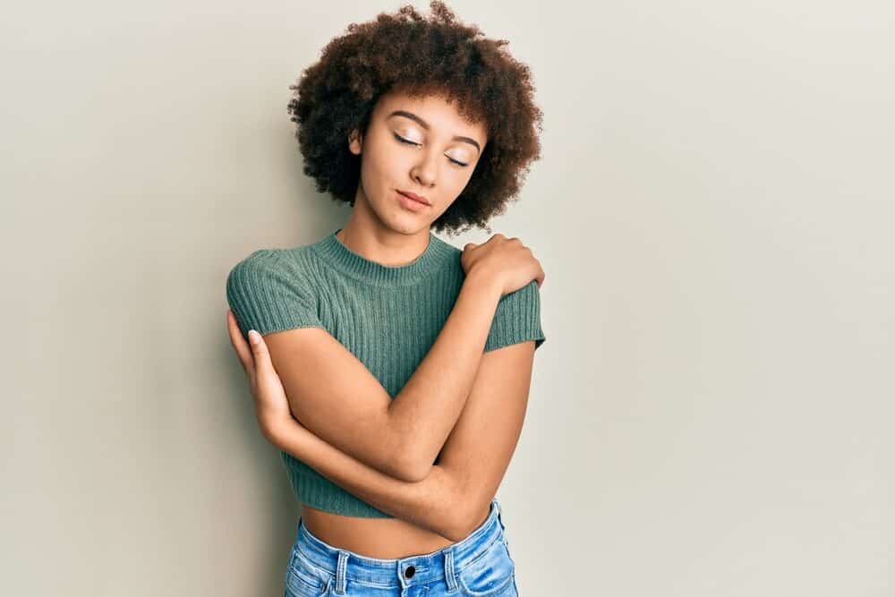 Hispanic lady with natural curls that follows the Curly Girl Method showing off her 3B hair type.