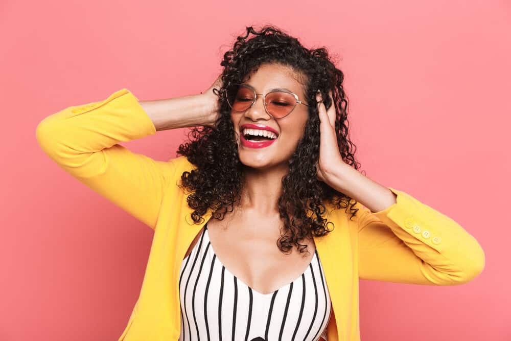 A cute woman with fine hair wearing loose curls that require little effort with her 3B hair type. 