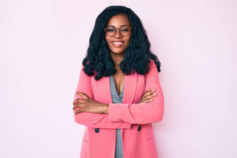 Beautiful African American with transitioning hair hydrated with wet and natural oils wearing a pink coat.