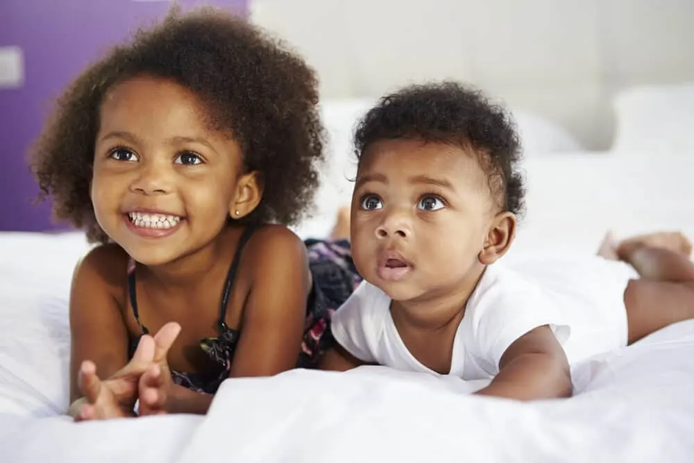 Baby Hair on Ultrasound vs When Born: When Can You Tell? 3 Two sisters with long hair watching television - one kid is 3 years old and the other is 40 weeks.