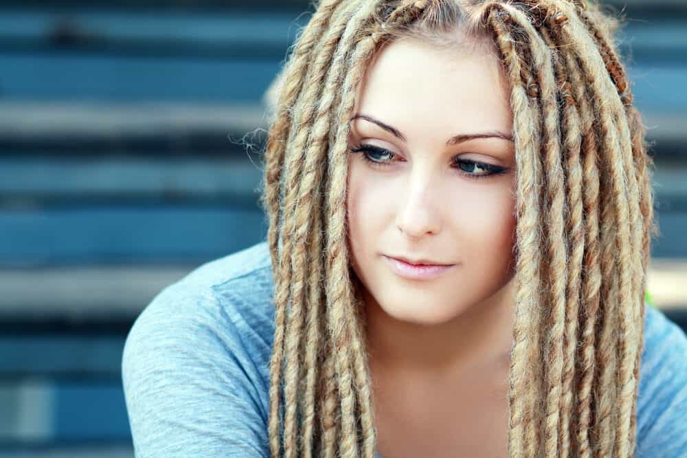 Lady with actual dreads on white hair that's more than just a hairstyle similar to those worn by Ancient Egyptians.