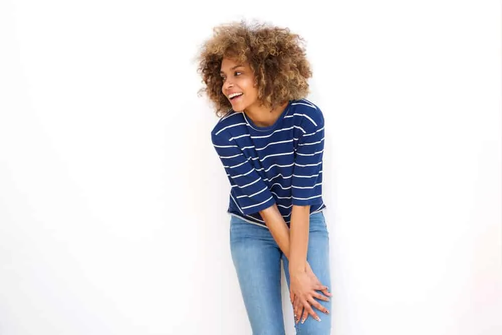 What Does Clarifying Shampoo Do to Colored Hair? Lighten? 6 A beautiful black lady with dry hair fibers just used a generous amount of leave-in conditioner on her curls.